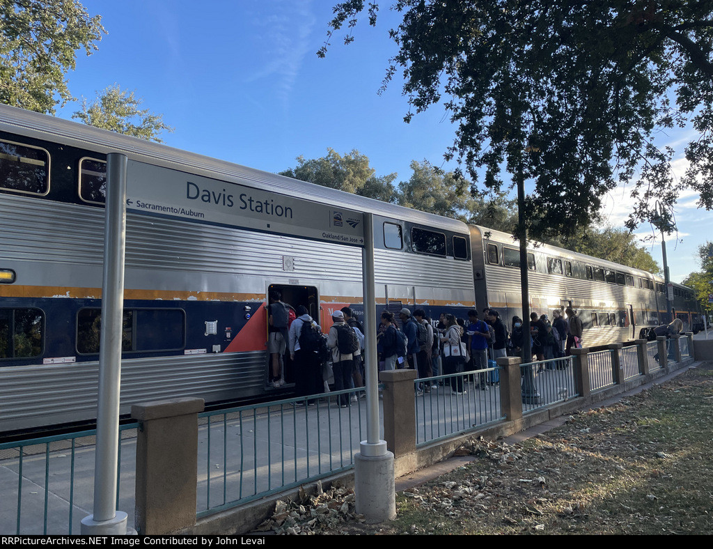 Several people board Amtrak Train # 547 at Davis, many of which are college students who attend UC Davis.